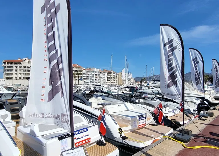 Boats on display in the harbor with Nautic Luis flags during the 2024 Used Boat Fair