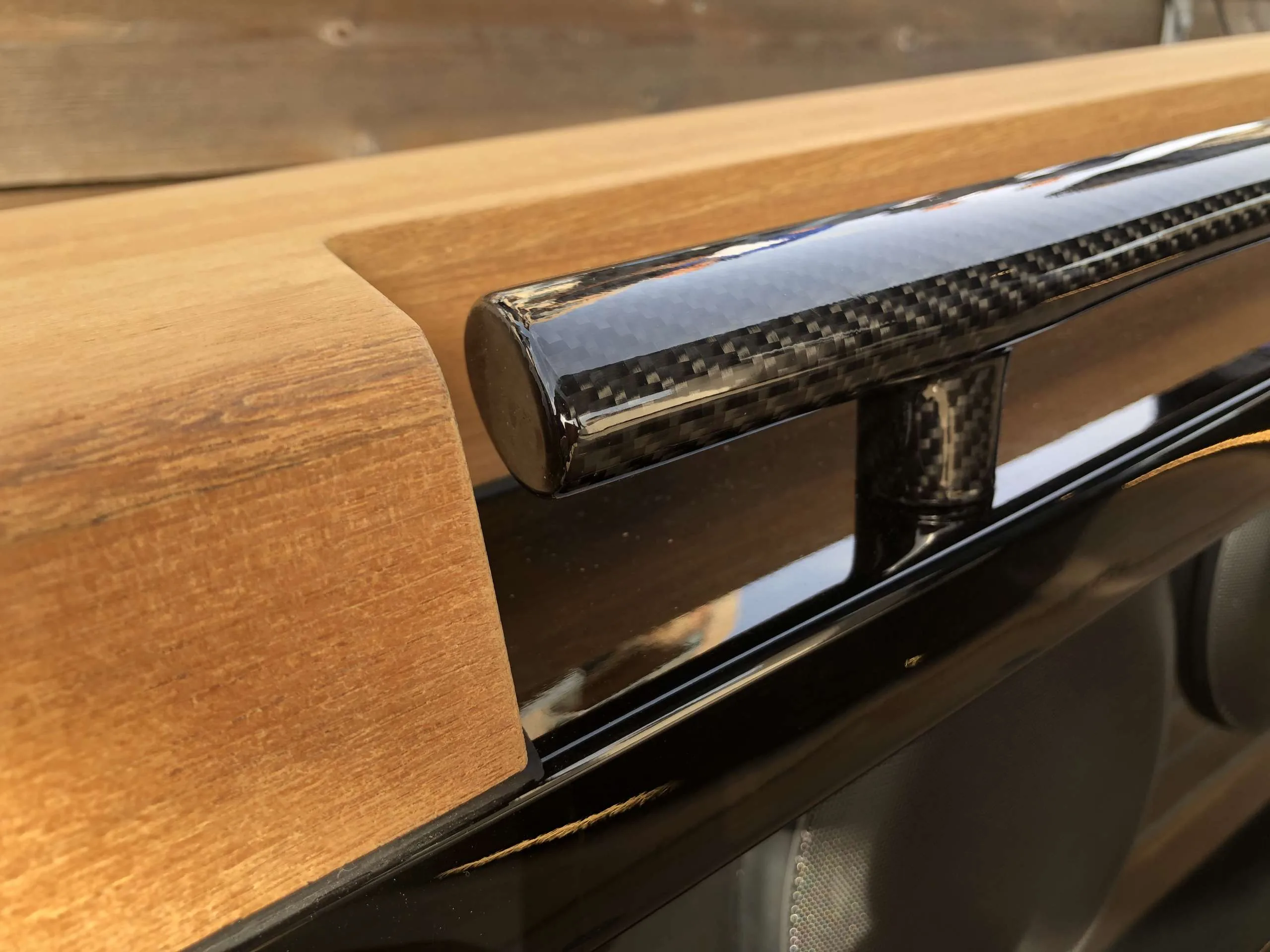 Exterior detail of the Windy SR 60: carbon handrails on a teak wood deck.