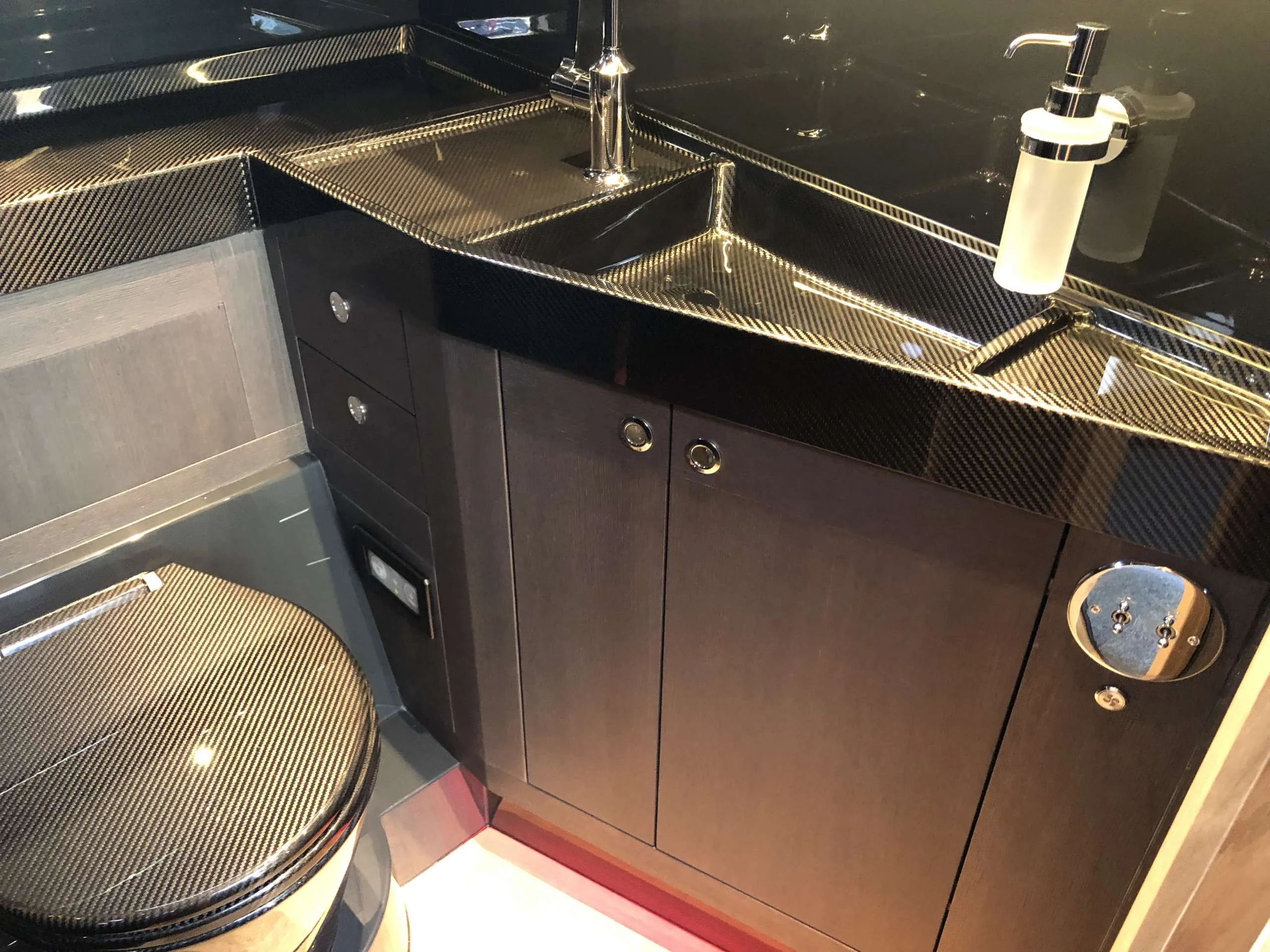 Interior of the Windy SR 60, with countertop, sink, faucet, dispenser, and black cabinets.