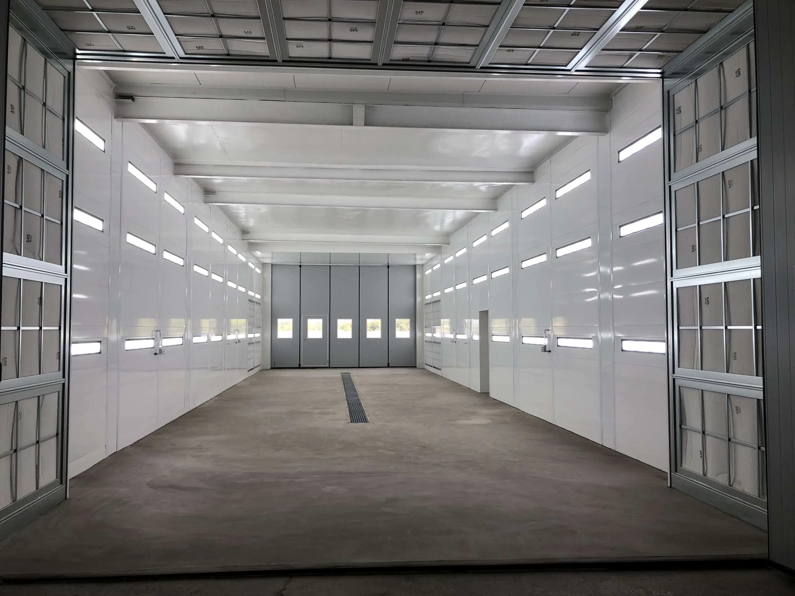 Empty industrial cabin interior showcasing the Windy SR 60, front view toward the doors at the rear.