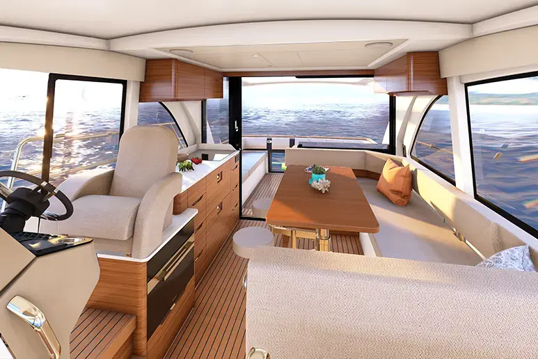 m390 car4 Interior de la Marex 390 visto desde popa, con salón, mesa, sofá, cocina y puesto de gobierno frente al mar