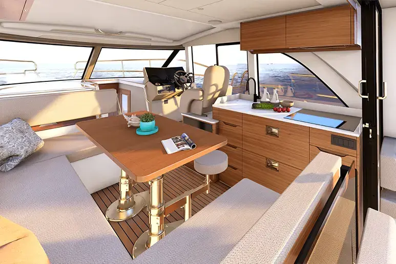 m390 car5 Interior del salón de la Marex 390, con mesa, bancos, cocina y puesto de mando visibles.