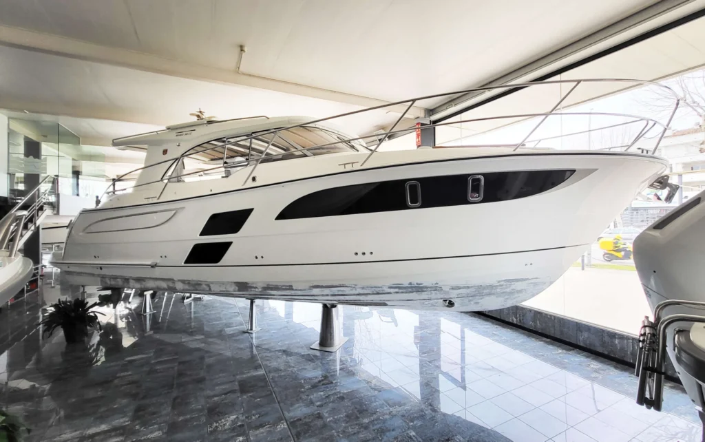 Marex 360 Cabriolet Cruiser d’occasion vu de profil lors d’une exposition nautique, sur des supports.