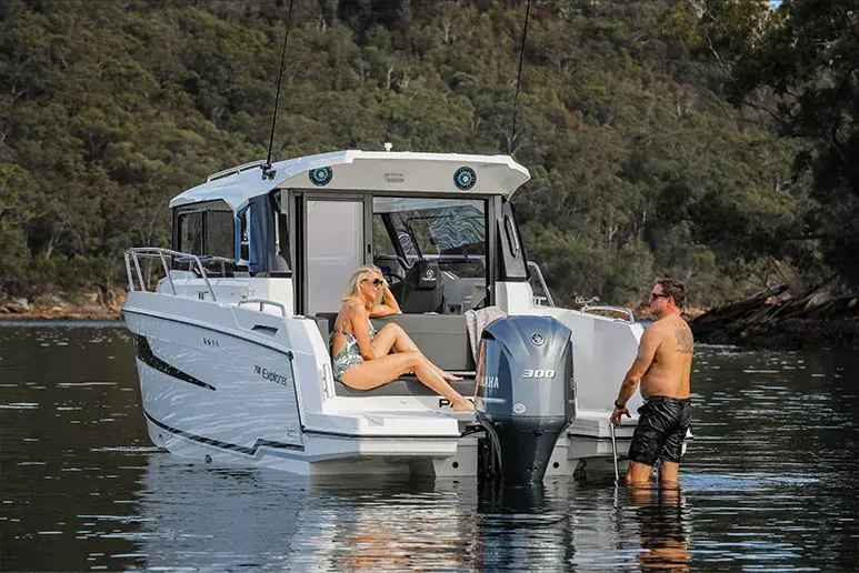 Parker 790 Explorer vom Heck aus gesehen, mit zwei Personen an Bord und einem Außenbordmotor auf ruhigem Wasser.