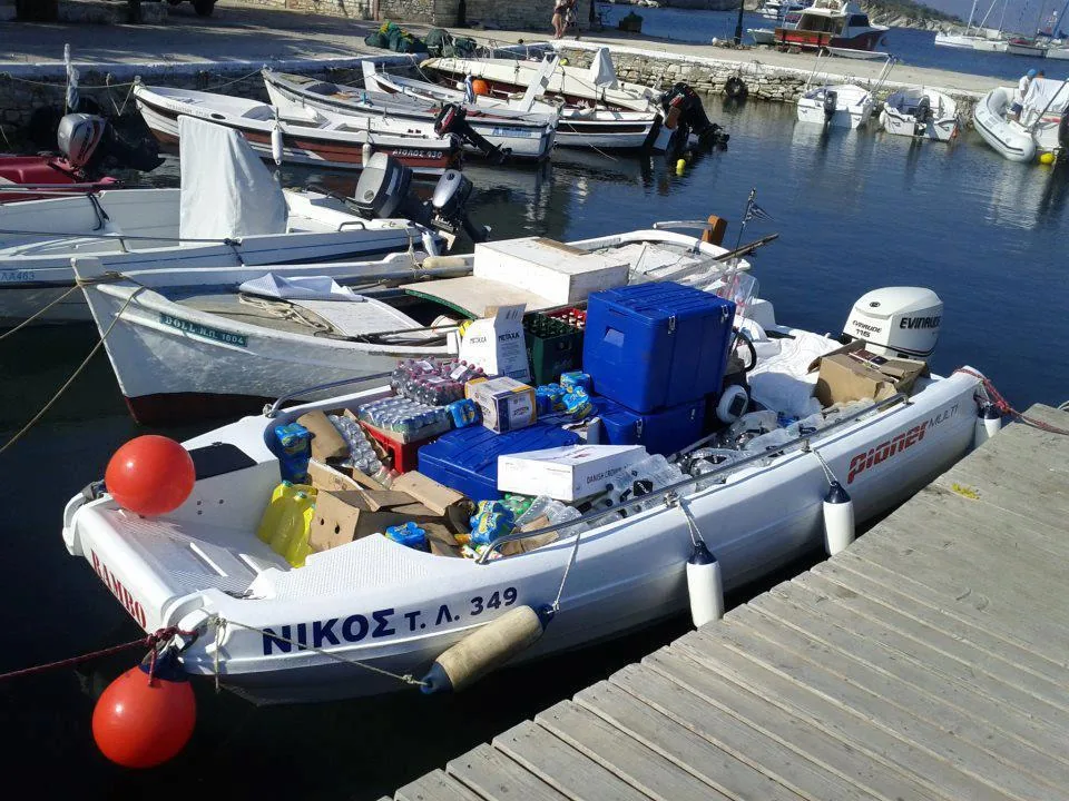 398010_568367473190849_923560739_n PIONER MULTI III seen from above, moored to the dock and loaded with boxes, jerry cans, and marine equipment.