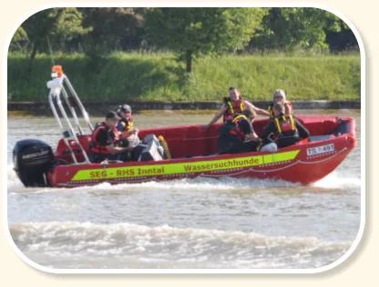PIONER MULTI III seen from the side, underway with six people and an outboard motor in open water.