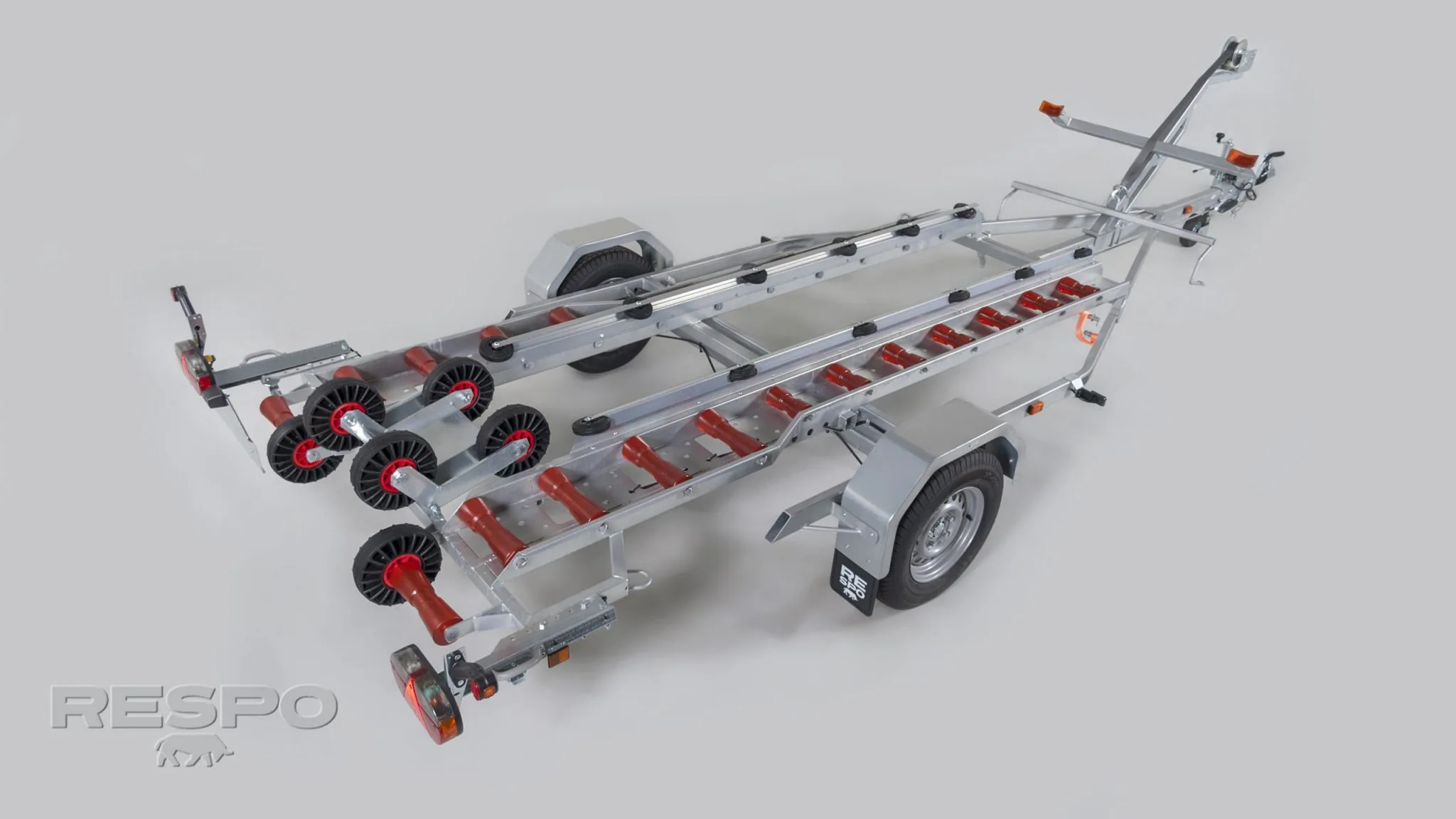 PIONER MULTI III on an aluminum boat trailer, oblique top view with red rollers, hitch and wheel.