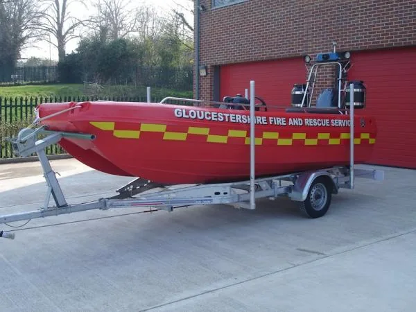 Red Pioner Multi III, exterior side view on a trailer, with yellow stripes and rescue text.