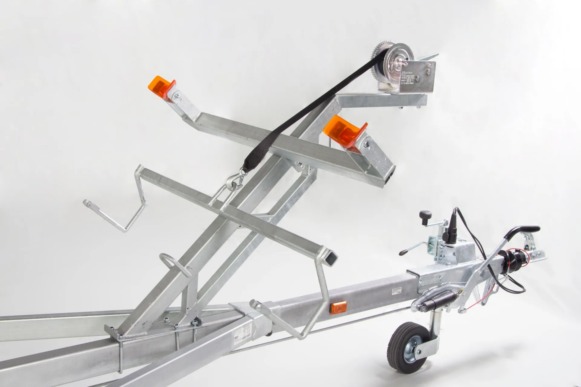 Galvanized trailer for PIONER MULTI III, side view, with winch, rollers, lights and jockey wheel.