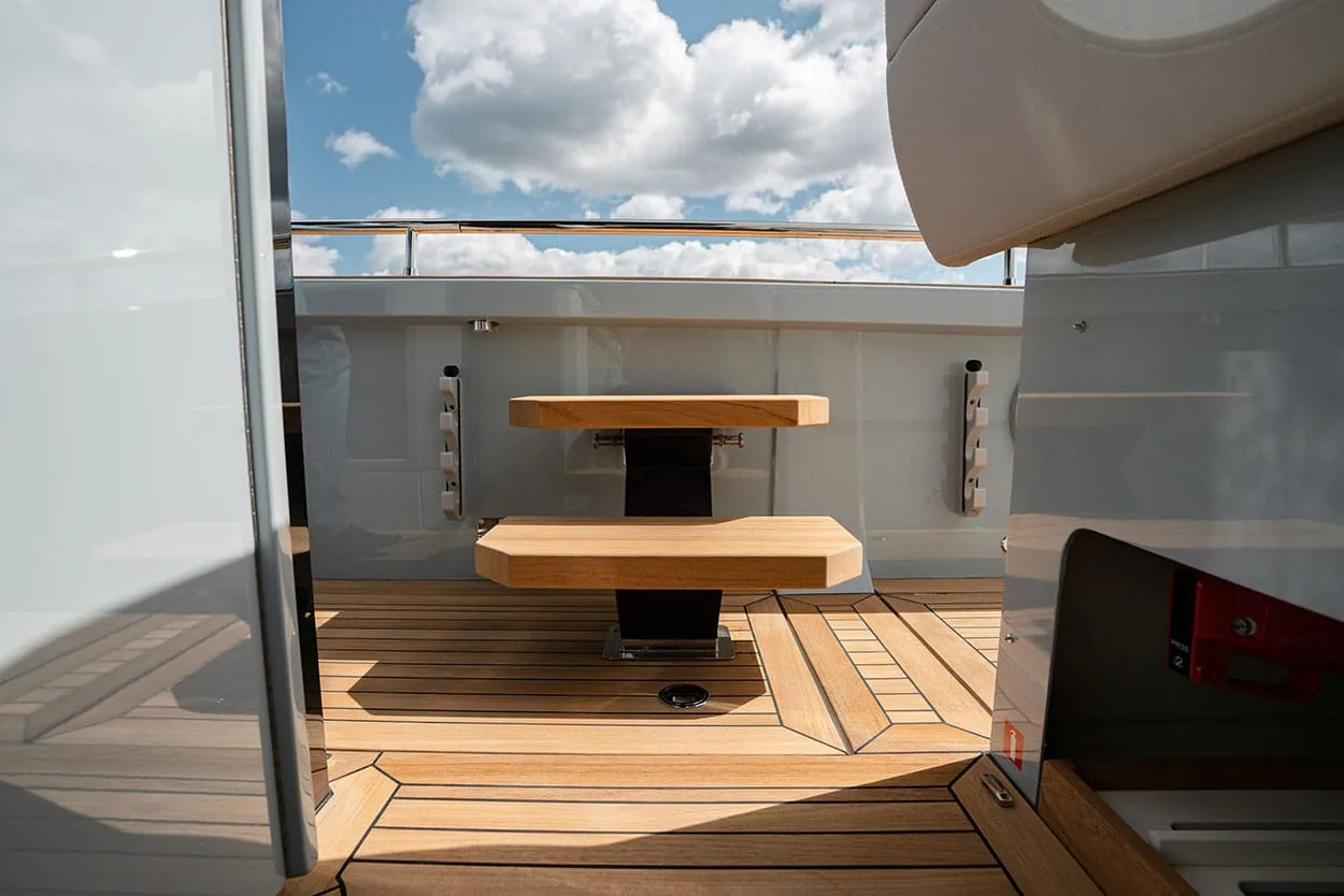 A7R04545 copy Windy SR52 Blackbird seen from inside looking toward the aft deck, with a table, benches and teak flooring.