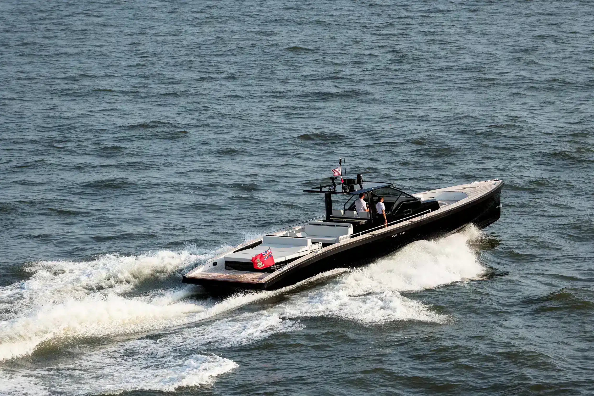 silken_2023-07-05-0590ps Windy SR52 Blackbird cruising in profile, with center console, canopy and two people on board.