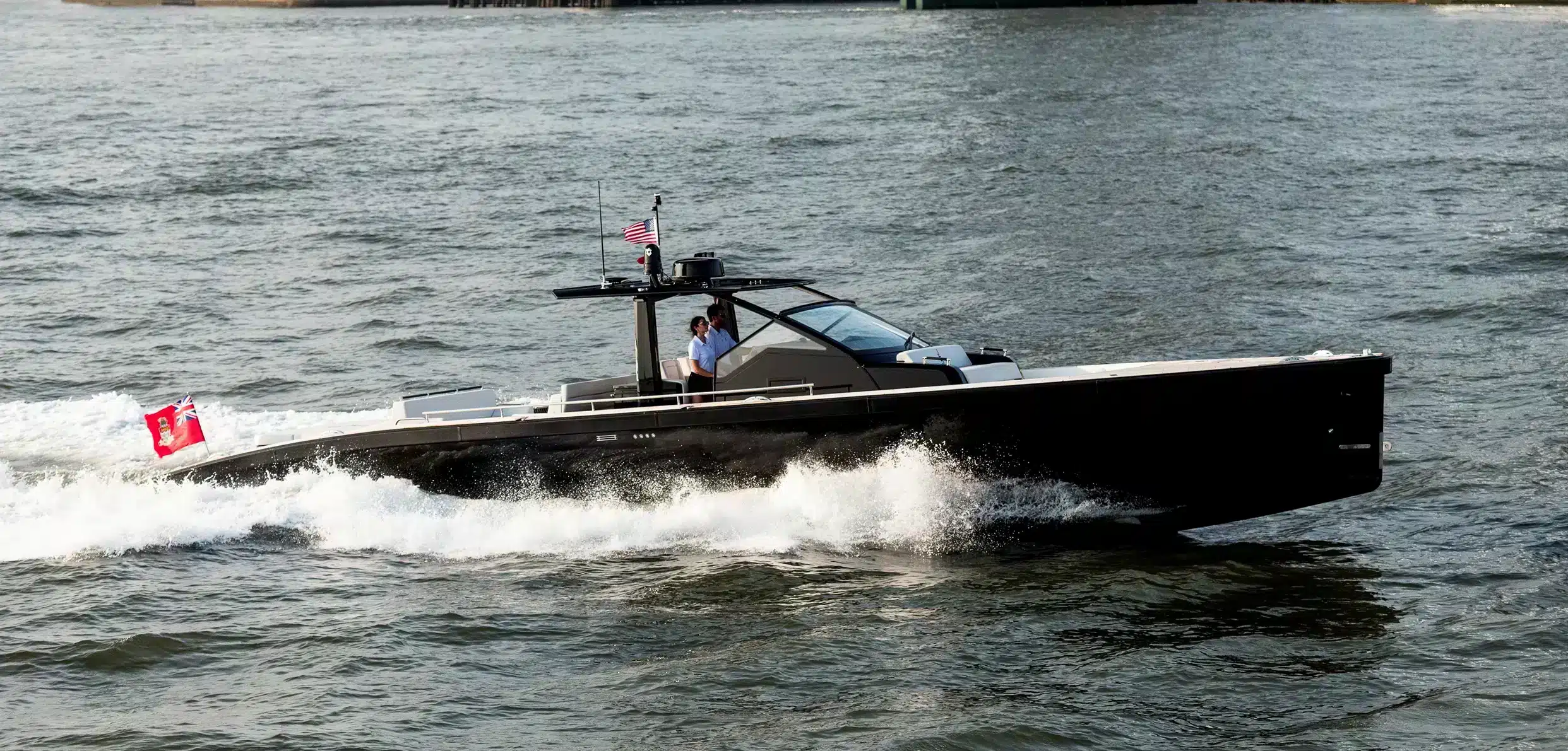 silken_2023-07-05-0954ps Windy SR52 Blackbird underway in profile, with a center console, windshield, and Canadian flag at the stern.