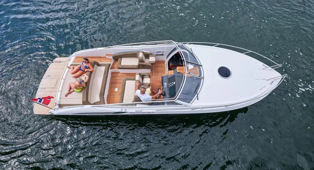 Windy 32 Grand Zonda seen from above, with three people, an aft sunbathing area, cockpit, and bow on the water.