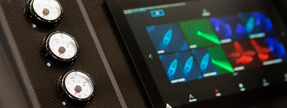 Interior control panel of the Windy 32 Grand Zonda, with three analog gauges and a navigation touchscreen.