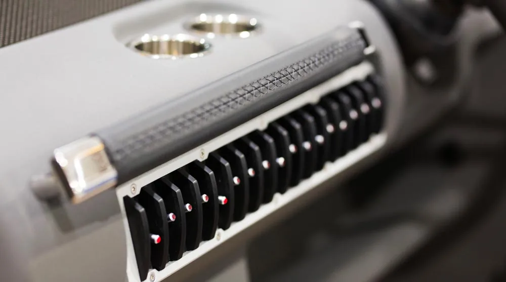 Detail of the interior control panel of the Windy 32 Grand Zonda, with black controls, red indicators and metal cup holders.