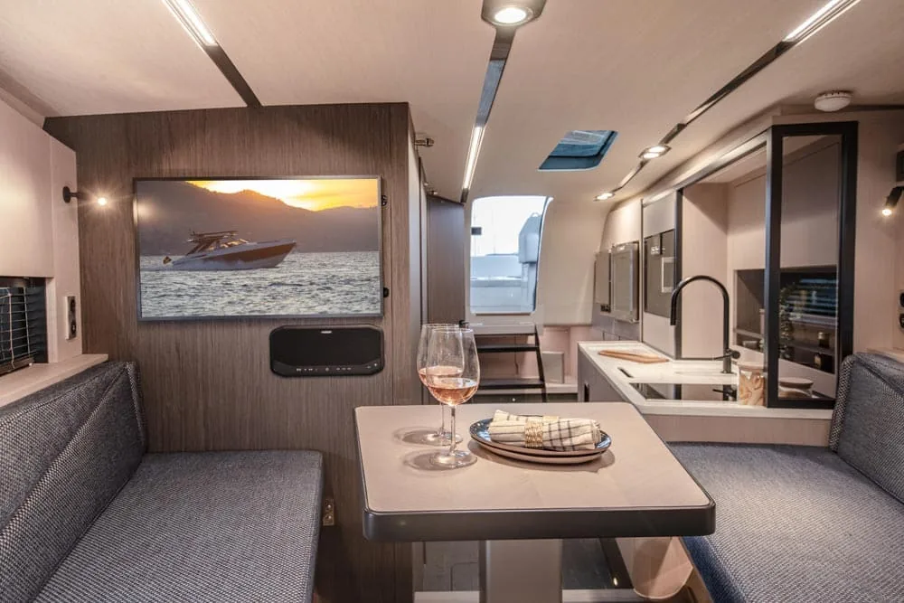 Interior of the Windy Camira 40 RS, salon and galley seen from aft, with table, benches and large windows.