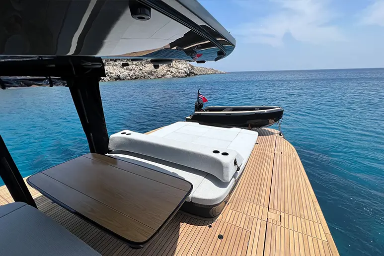 Cockpit with open side corridors of the Windy SR60 and a Dinghy on the platform